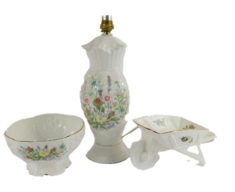 A group of Aynsley porcelain decorated in the Wild Tudor pattern, comprising Windsor lamp, wheelbarrow, and trinket dish, all