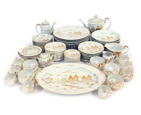 A Japanese porcelain part tea and dinner service, each piece decorated in gilt with scenes depicting buildings, etc., gilt he