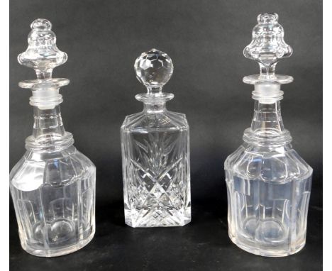 Three cut glass decanters, comprising decanter of square form, with stopper, 26cm high, and two similar mallet shaped decante