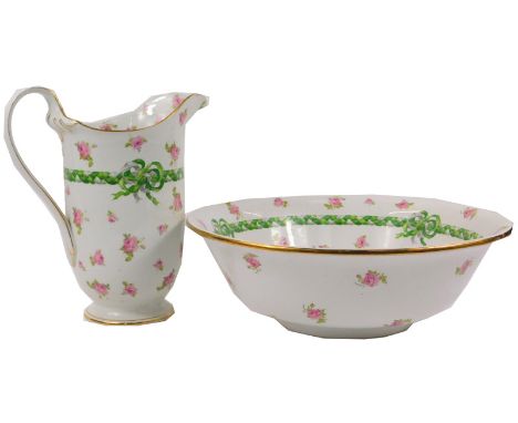 A Grimwades Winton ware pottery wash jug and bowl, decorated with pink roses and plaited grey and green bow, on a white groun