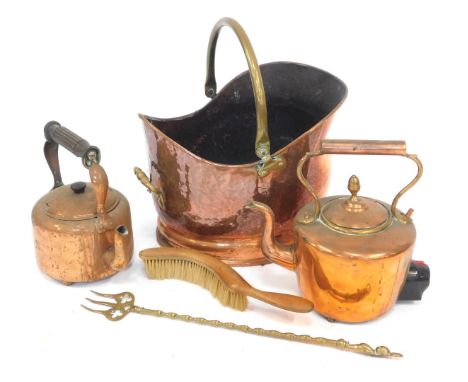 A hammered copper helmet shaped coal scuttle, with brass ring handle, together with copper kettle, fireside implements, etc. 