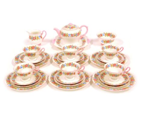 A Shelley porcelain part tea service, decorated with flowers against a white ground, pink bordered, to include teapot, teacup