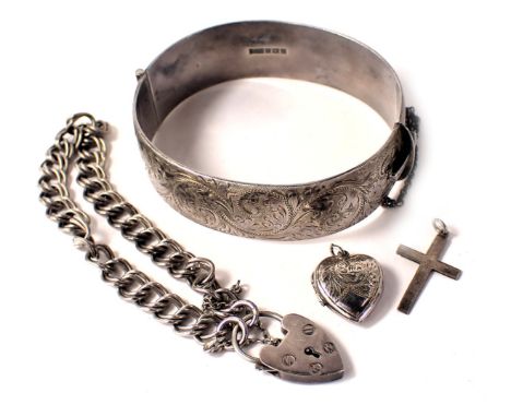 A group of silver jewellery, comprising a silver half hinged bangle with floral scroll decoration and safety chain, 6.5cm dia