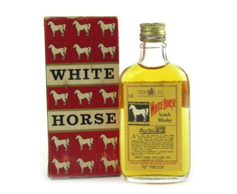 A miniature bottle of White Horse Scotch whisky, in box, 12cm high. 