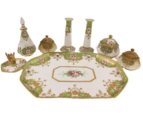 A Noritake porcelain dressing table set, decorated with roses, with a green border, gilt heightened, comprising tray, 32cm wi