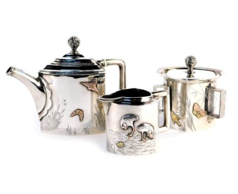 A Victorian Aesthetic influence silver three piece tea service, comprising teapot, lidded three handled sugar bowl and milk j