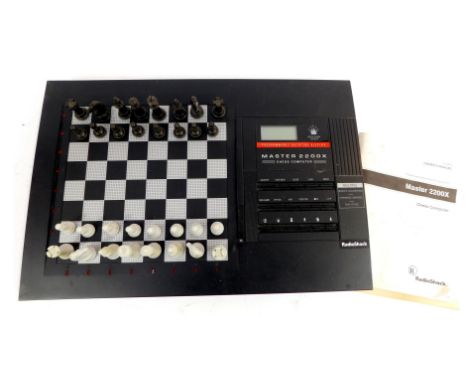 A Radio Shack Master 2200X chess computer, 60-2213, with owners manual and charging cable. 