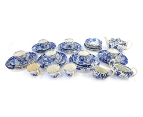 A Royal Doulton porcelain part tea service, decorated in blue and white with Oriental figures and buildings, against a white 