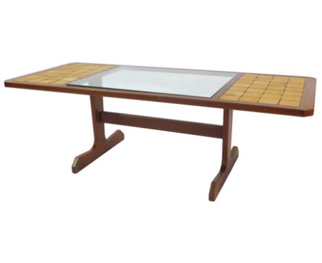 A tile and glass topped teak coffee table, 135cm x 57cm.