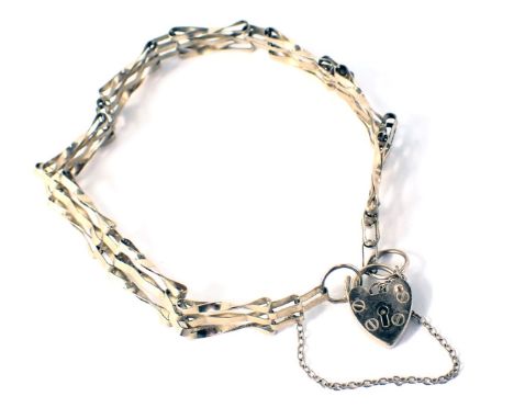 A 9ct gold three bar gate bracelet, with safety chain heart shaped padlock, 16cm long, 4.9g. 