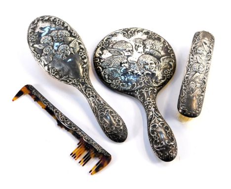 A Victorian silver backed dressing table set, comprising hair brush, hand mirror, clothes brush and comb, each piece repousse