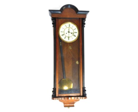 A walnut and ebonised cased Vienna style wall clock, the cream enamel dial bearing Roman numerals, eight day movement, with p