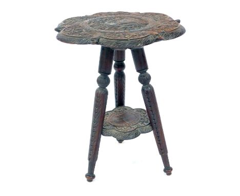 An Eastern hardwood carved teak tripod table, 46cm high, 39cm diameter.