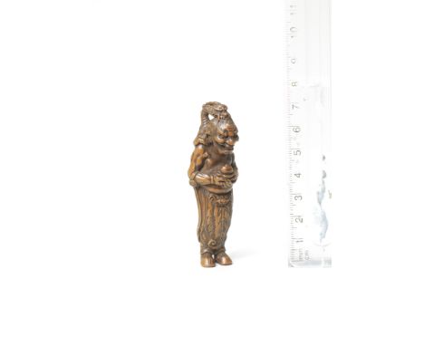 A wood netsuke of RyujinBy Tametaka, Nagoya, 18th centuryThe Dragon King with a fierce expression, standing and holding the t