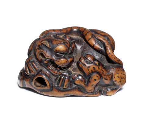 A boxwood netsuke of a tiger and cubBy Masayoshi, 19th centuryThe parent resting on a rocky outcrop, turning to its left, fac