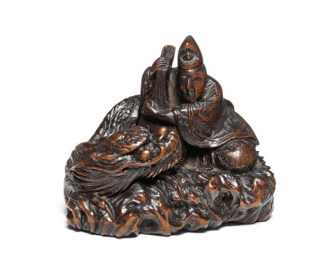 A wood netsuke of a nobleman and a dragonBy Masakazu, 19th centuryThe nobleman sitting on a rock, clutching a biwa (lute), th