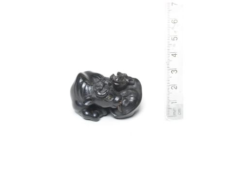 An ebony netsuke of a recumbent ox and youngBy Tanaka Minko (1735-1816), Tsu, Ise Province, late 18th/early 19th centuryThe p