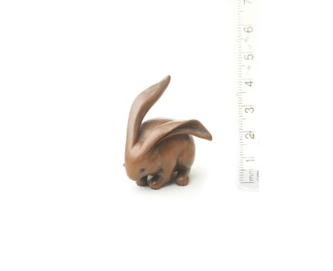 A wood netsuke of a long-eared rabbitAttributed to Ranko, 19th centuryThe small rabbit with its legs drawn in, forming a comp