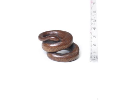 A boxwood netsuke of a coiled snakeBy Kashu, late 18th/early 19th centuryThe snake elegantly coiled in two loops, its body in