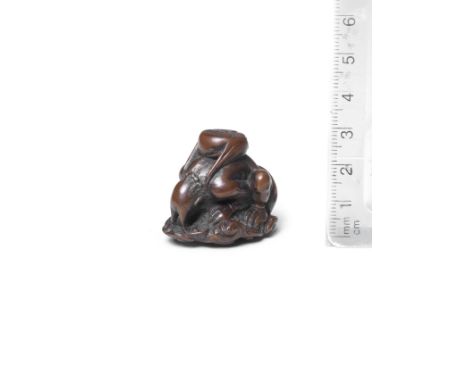 A wood netsuke of RaijinBy Ittan, Nagoya, mid-19th centuryThe god of thunder seated on a swirling cloud, peering down through