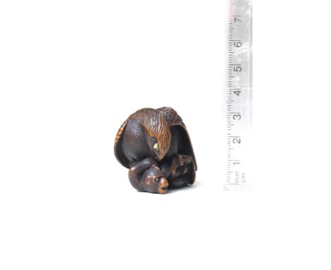 A wood netsuke of an eagle and monkeyBy Masatsugu, 19th centuryThe eagle crouching, leering down at the monkey pinned down in