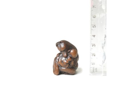 A wood netsuke of KuzunohaBy Masakazu, Nagoya, 19th centuryThe fox seated in a human attitude, protectively holding the infan