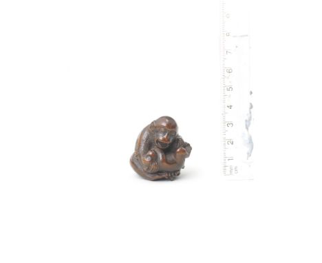 A wood netsuke of a monkey with youngBy Masanao, Yamada, Ise Province, early/mid-19th centuryThe parent tenderly holding its 