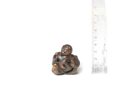 A wood netsuke of an octopus and monkeyEarly/mid-19th centuryThe octopus and monkey locked in combat, the monkey grappling wi