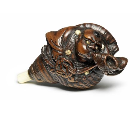 A wood netsuke of BenkeiBy Mitsushige, early 19th centuryBenkei wearing the garb of a Yamabushi warrior-priest, sitting in la