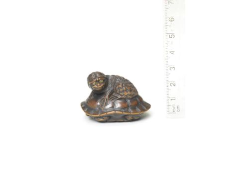 A wood netsuke of a kappa on a tortoiseBy Naito Toyomasa (1773-1856), Tanba Province, early 19th centuryThe kappa with a bemu
