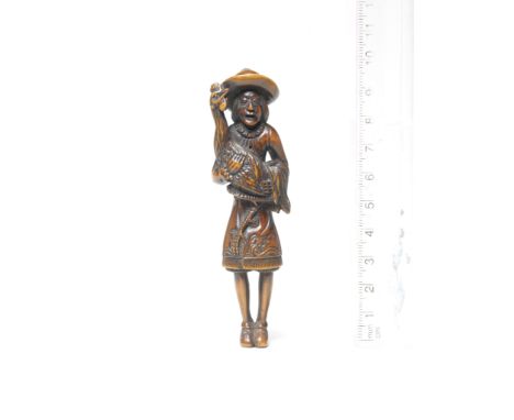 A wood netsuke of a Dutchman18th centuryThe slender Dutchman standing, his mouth open, holding a large rooster in his arms, h