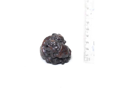 A wood netsuke of two shishiBy Tametaka, Nagoya, 18th centuryThe two shishi seated, curled around each other, their heads res