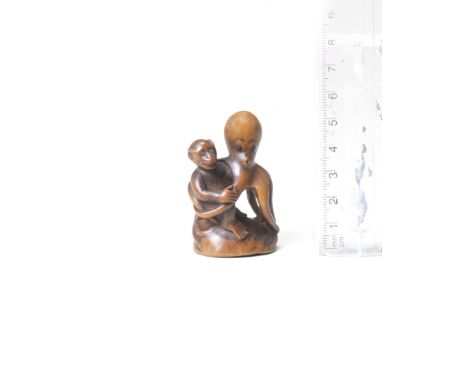 A wood netsuke of a monkey and octopusBy Tanaka Minko (1735-1816), Tsu, Ise Province, late 18th/early 19th centurySitting sid