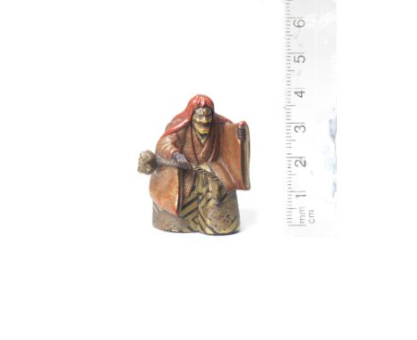 A lacquered wood netsuke of a Noh actorBy Issai, late 19th centuryAssuming the role of Kiyohime in the play Dojoji, the actor