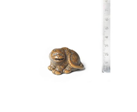 A wood netsuke of a tigerBy Minsai, Tsu, Ise Province, early 19th centuryThe tiger seated, snarling as it turns its head to t