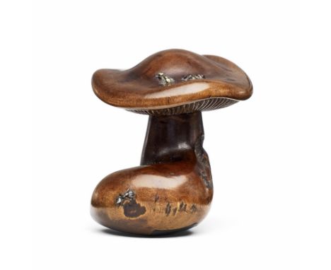 A wood netsuke of a mushroom with inlaid metal antsBy Jikan Ganbun, Kyoto and Tokyo, late 19th centuryThe mushroom with a bro