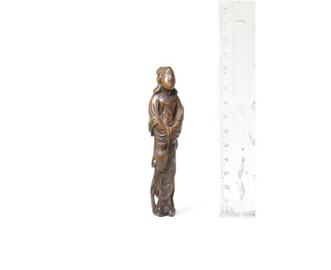 A wood netsuke of Seiobo with a basket of peaches18th centuryThe Queen Mother of the West standing, leaning back slightly and