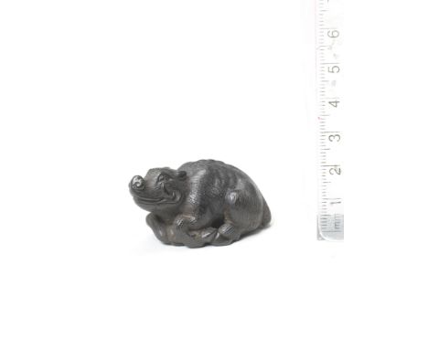 A wood netsuke of a recumbent boarBy Kokei, Kuwana, Ise Province, late 18th centuryThe boar lying with its head raised, turni