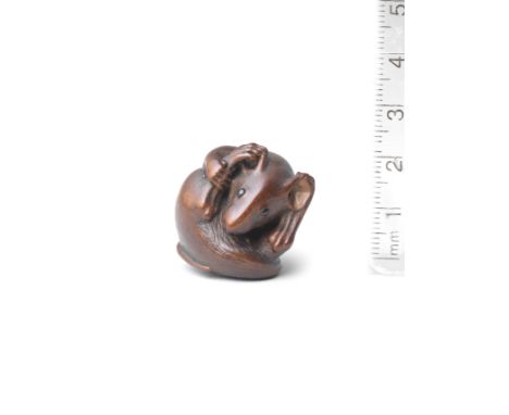 A wood netsuke of a coiled ratBy Nobuyoshi, mid-late 19th centuryThe small rat curled up in a ball, cleaning itself, its feet