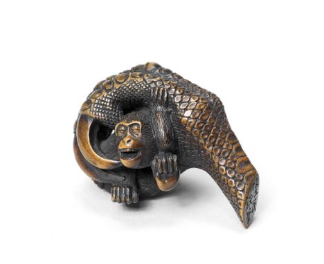 A wood netsuke of a monkey in an eagle's clawBy Ryumin, 19th centuryThe monkey crying out, struggling to escape the clutches 