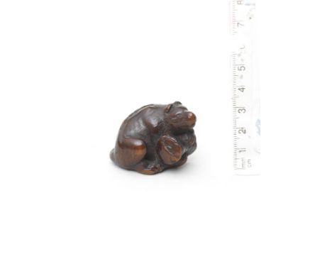 A wood netsuke of a fox with a drum (Kitsune Tadanobu)By Kokei, Kuwana, Ise Province, 19th centuryThe fox seated, leaning for