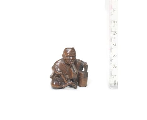 An okimono-style wood netsuke of oni no nenbutsuBy Kyokumin, mid-late 19th century The demon seated wearing a solemn expressi