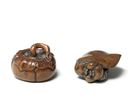 Two boxwood netsuke of vegetable subjects19th centuryThe first a persimmon open on the underside revealing a large spider cra
