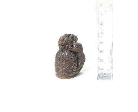 A wood netsuke of Kiyohime on the Dojoji bellBy Tametaka, Nagoya, late 18th centuryFully transformed into a dragon, the witch