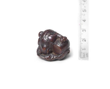 A wood netsuke of RaijinBy Kokei, Kuwana, Ise Province, late 18th centuryThe god of thunder seated on a swirling cloud, peeri