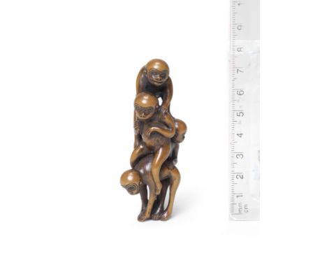 A wood netsuke of a pyramid of monkeys18th centuryComposed of five monkeys climbing one on top of the other, forming an elong