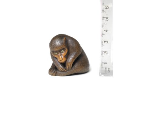A boxwood netsuke of a monkeyBy Koichi, late 19th centuryThe monkey seated, its head lowered, turning slightly to the left, p