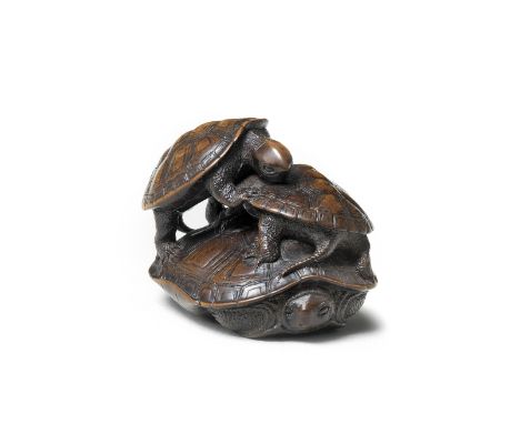 A wood netsuke of a turtle with two youngBy Kano Tomokazu, Gifu, mid-19th centuryThe adult tucking its head and legs inside i
