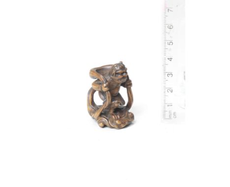 A wood netsuke of Futen with his bag of windBy Kiraku, late 19th centuryThe wind god walking, wearing an intense expression o