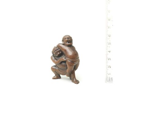 A wood netsuke of Kawazu Sukeyasu and Matano KagehisaBy Masakazu, Gifu, late 19th centuryThe two famous sumo wrestlers locked